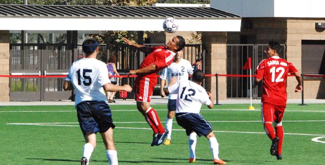 Luis Venegas controls a ball in the air right in front of teammate Leonardo Contreras. Each had a goal in the Dons 2-0 win over LA Mission College.