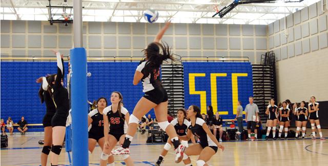 Michelle Nguyen attacks at the net against two defenders in the Dons loss to Rio Hondo College.