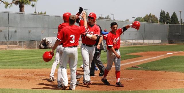 Konnor Armijo (center) is congratulated by teammates at home plate following a home run.