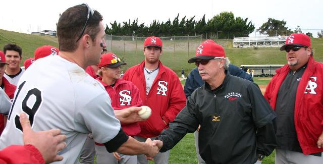 Don Sneddon is congratulated by a player following his record-tying 831st win in 2006. Sneddon is stepping down as the game's all-time leader in wins with 1,072.