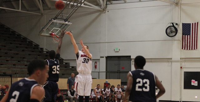 Chase Miller launches a three-pointer over a Fullerton defender in the Dons 108-102 win. Photo by Tony McAndrew.