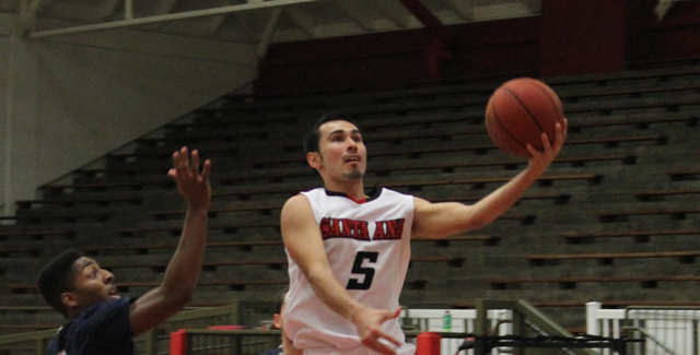 Kevin Ramirez lays in a shot as he led the Dons with 15 points. Photo by Tony McAndrew.