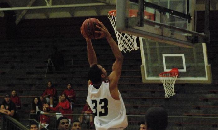 Justin Bryan dunks the ball in the Dons game against Cypress College. Bryan finished tied for third on the team with 11 points.