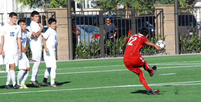 Leonardo Contreras bends this shot around the Hawks defensive wall for the first goal of the Dons 2-2 tie with Santiago Canyon College.