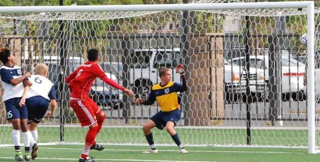 Jesus Lopez (red jersey) watches as his goal sneaks in past the right post in the Dons 3-1 victory over Cypress College.