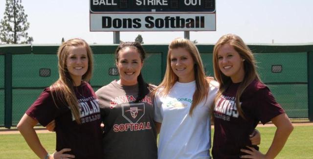 From left to right, Kristen Hooper, Hannah Dowling, Rachel Prentice and Kaitlyn Hooper pose on the softball field after signing letters of intent to their respective schools.