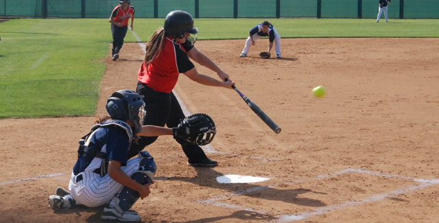 Danielle Hernandez drives a ball to right field for a three-run triple in the Dons win over Fullerton College.