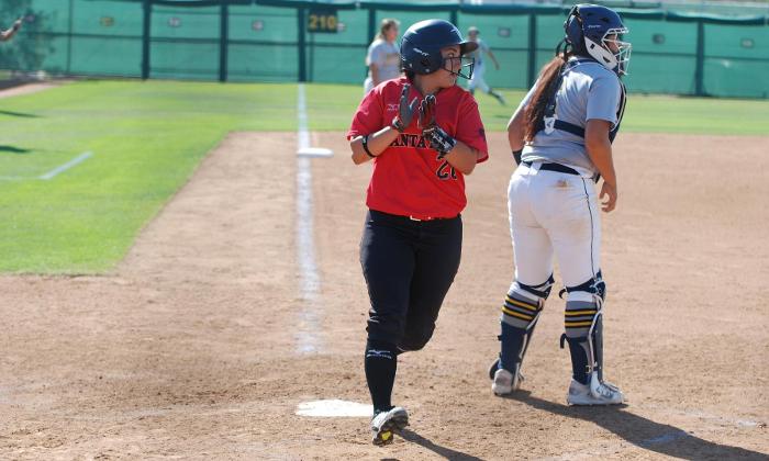 Alexandra Hernandez celebrates after crossing home plate as she scored the only run of the game on a RBI-single by Desiree Hernandez.