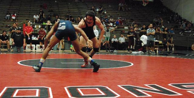 Joaquin Collister sizes up his opponent in his final match of the 2014 Santa Ana College Tournament. Collister was the Dons top finisher in second place.