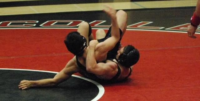 Joaquin Collister rolls his opponent back in the Dons match against Palomar College.