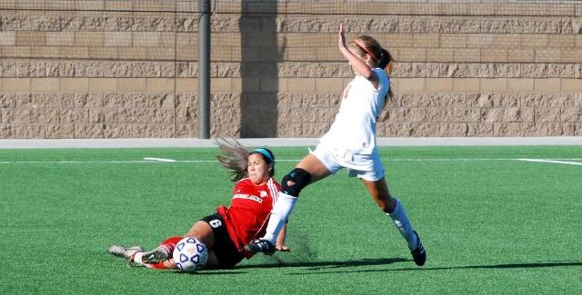 Bereniz Velazquez slides to keep the ball away from an Orange Coast player in the Dons Orange Empire Conference opener.