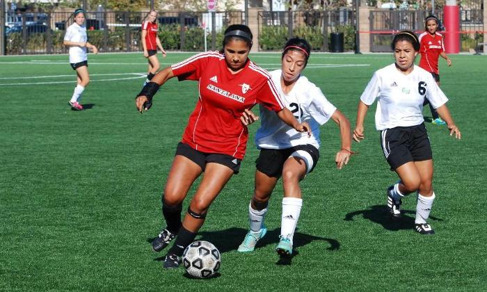 Cristina Lizarraga fends off a Golden West player to control the ball near midfield.