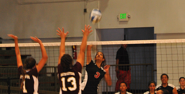 Tori Sparks hits an attack over two defenders in the Dons non-conference match with Southwestern College.